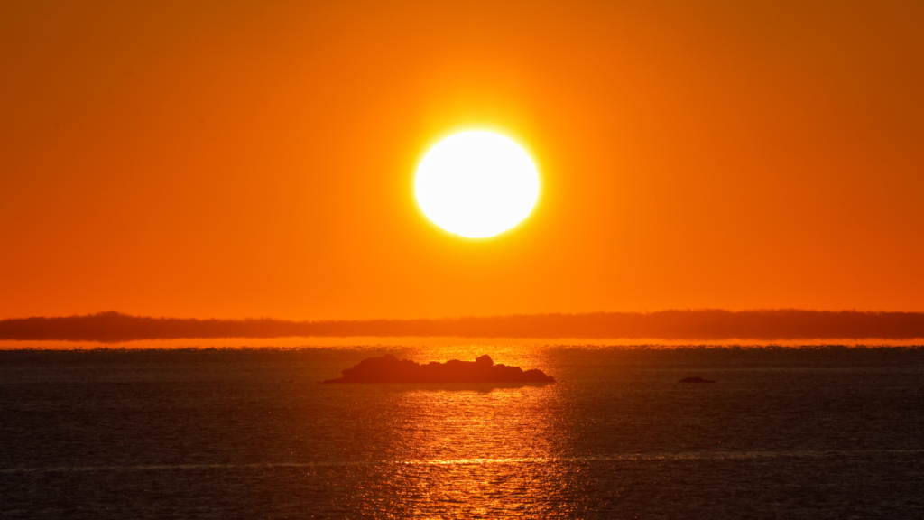 An image of a sunset overlooking an island depicting a tough time which matches with the title How To Get through A Tough Time - Tips From A Mindset Coach - Part 1